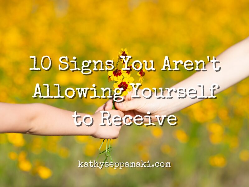 10 Signs You Aren't Allowing Yourself to Receive Blog Post with picture of a child handing a bunch of yellow daisys to a woman in a field of daisies