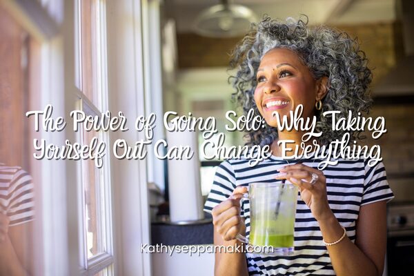 The Power of Going Solo: Why Taking Yourself Out Can Change Everything blof post title with picture of woman holding a coffee beverage looking out of a cafe window and smiling