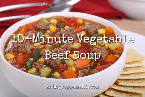 10-minute vegetable beef soup blog post title with picture of a large white bowl of vegetable beef soup sitting on a table.