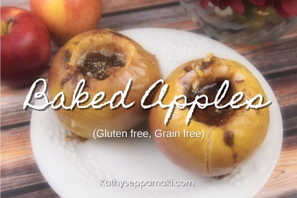 Baked Apples blog post title with a picture of two baked apples on a white plate sitting on a wooden table.