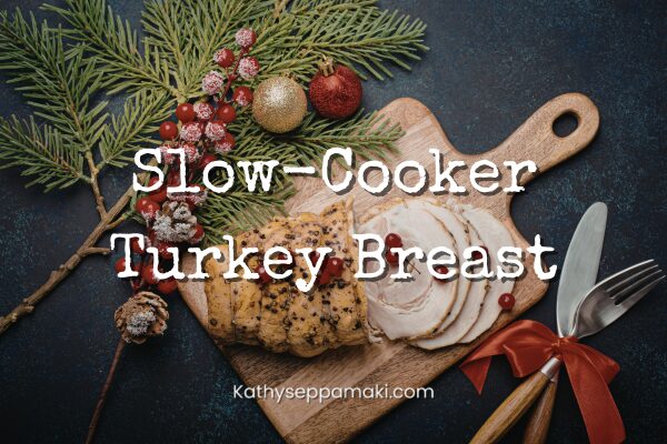 Slow-cooker turkey breast blog post title with picture of a sliced turkey breast on a cutting board surrounded by holiday greenery and decorations.