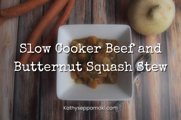 Slow cooker beef and butternut squash stew blog post title with a picture of a white, square bowl full of stew sitting on a wooden table.