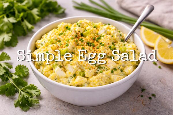 Simple egg salad blog post title with a picture of a white bowl filled with egg salad.