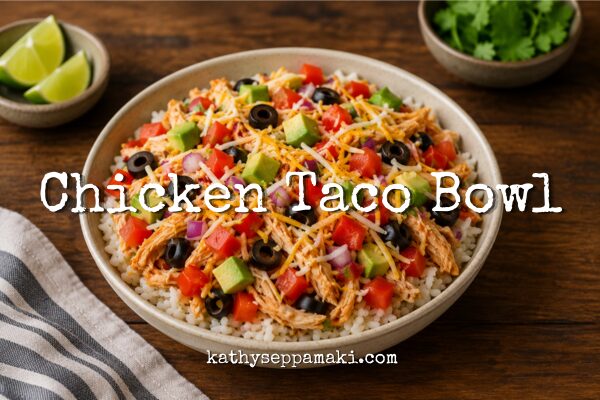 Chicken Taco Bowl blog post title with a picture of a white chicken taco bowl sitting on a dark rustic table.