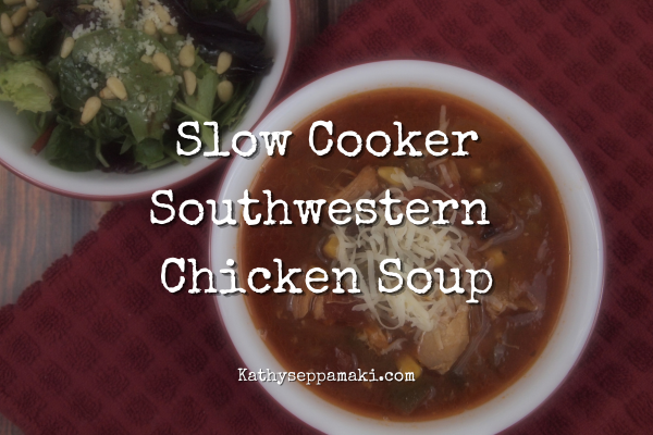 Slow Cooker Southwestern Chicken Soup blog post title with photo of a bowl of the soup next to a salad on a wooden table top